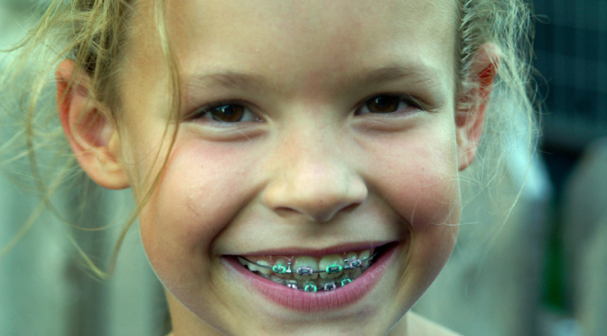 young girl with braces smiling
