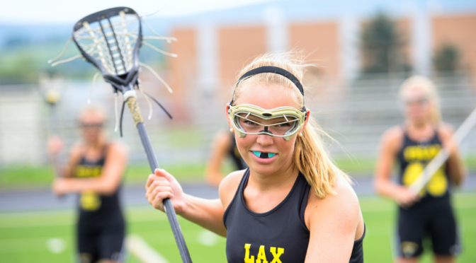 girl lacrosse player wearing mouthguard