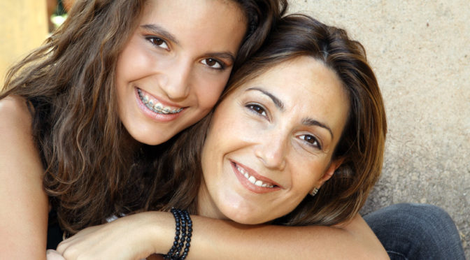 mother and daughter with braces smiling