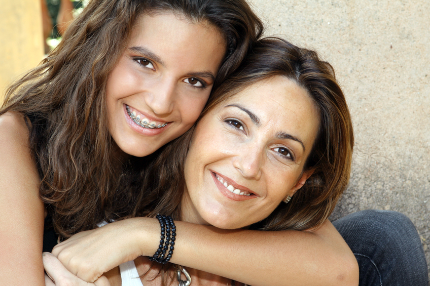 mother and daughter with braces smiling