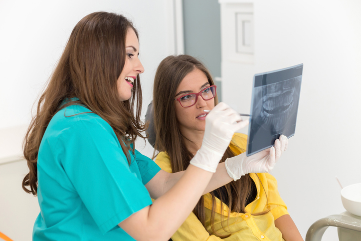 dentist showing patient xrays